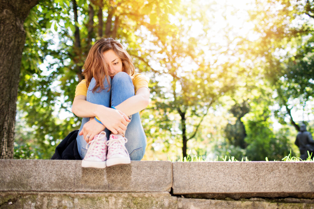 girl-with-anxiety-looking-worried-while-oustide-in-park