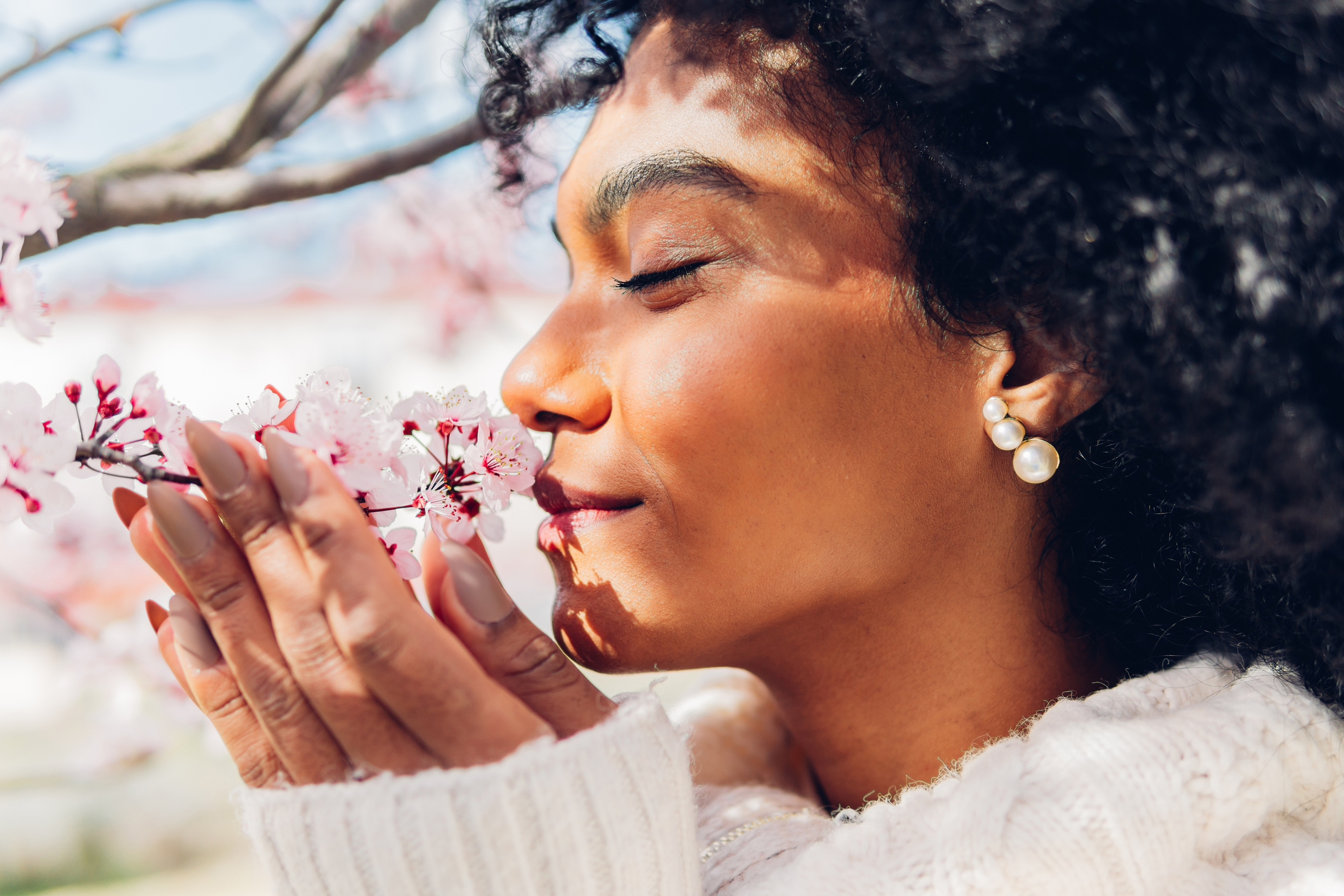 woman-smelling-flowers-enjoying-nature