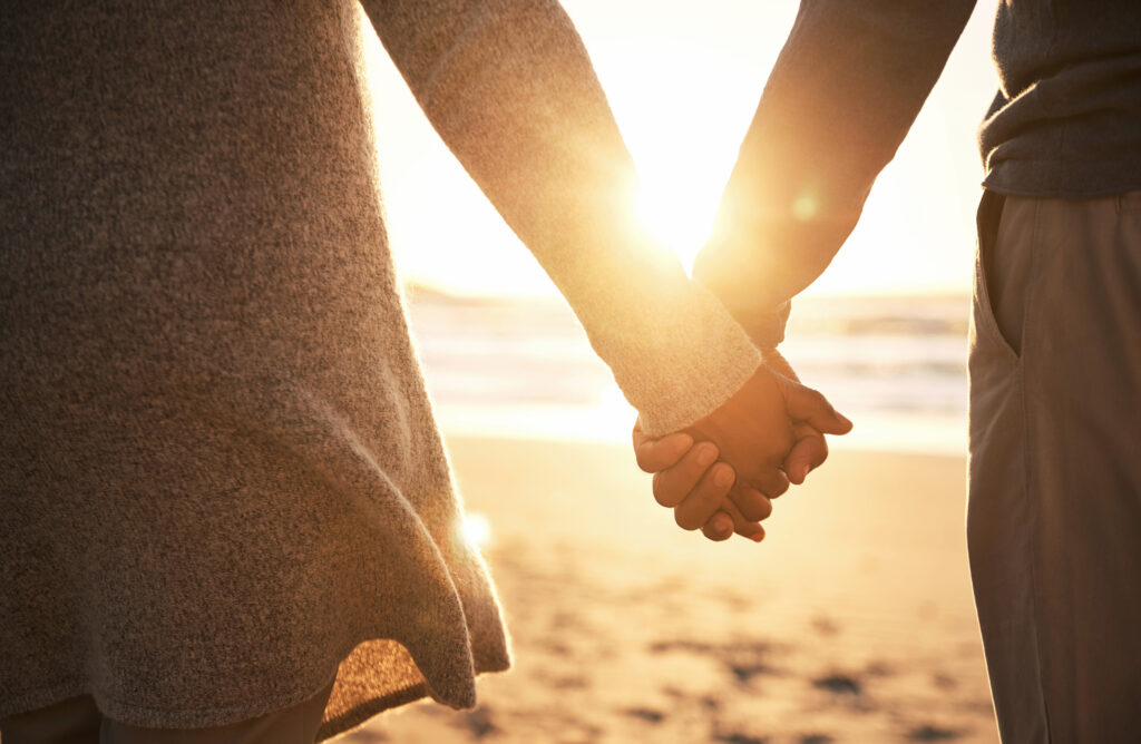 couple-holding-hands-on-beach-after-therapy